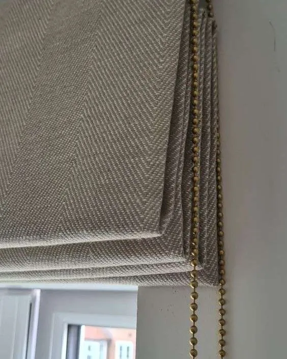 Cream roman blind with soft folds in a Dubai home