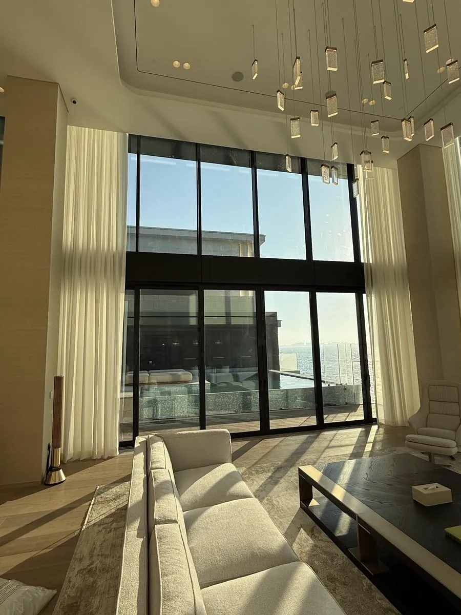 White sheer curtains diffusing daylight in a Dubai apartment with a sea view