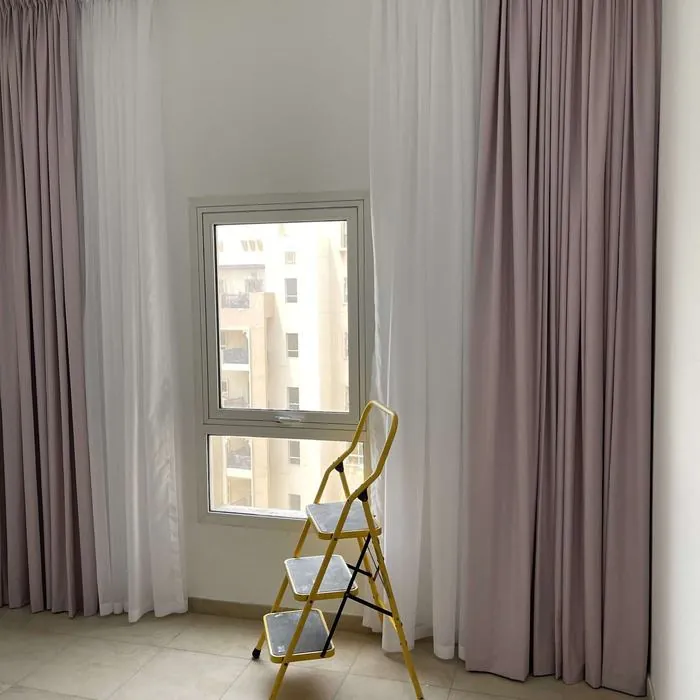 Mauve curtains with white sheers in a UAE living room